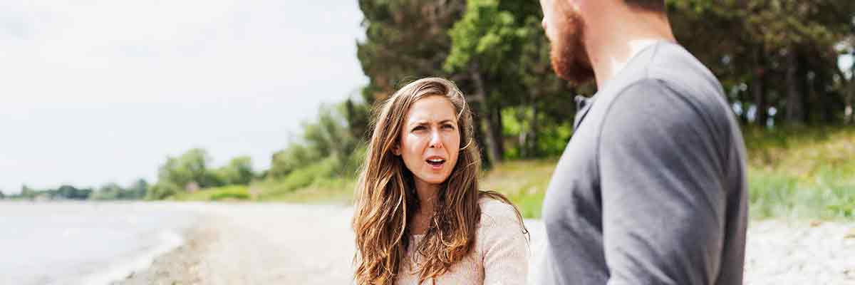 man-and-woman-discussing-at-beach
